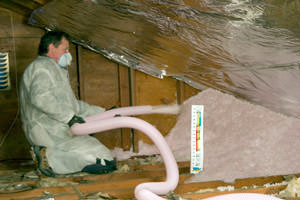 Fiberglass Insulation being used to add energy efficiency to an attic in Indianola