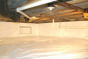 An energy efficient, insulated crawl space with a vapor barrier installed.